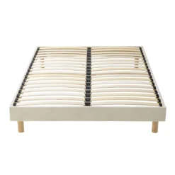 Lit tissu beige avec tête de lit bouclette